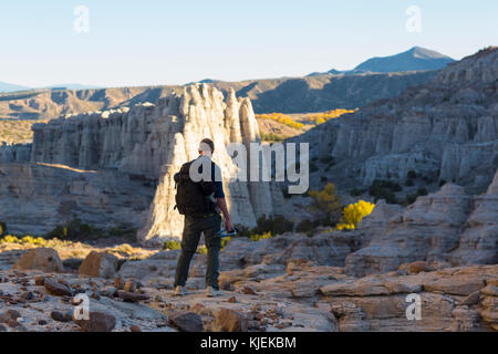 Caucasian man carrying backpack in desert Stock Photo