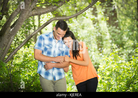 Couple hugging in the woods Stock Photo