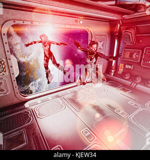 Women floating in space suits inside spaceship Stock Photo