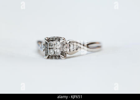 Detail shot of diamond wedding ring against a plain white background Stock Photo