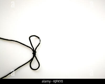 Rope bow black color on white isolated background. Stock Photo