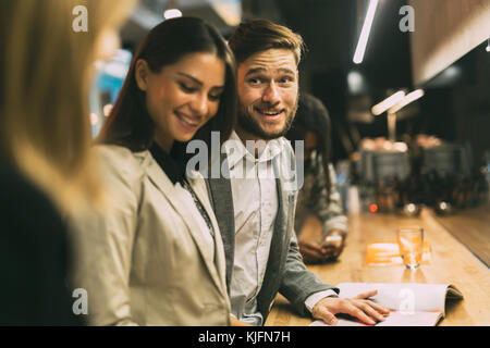 Friends at the counter of a bar after work Stock Photo