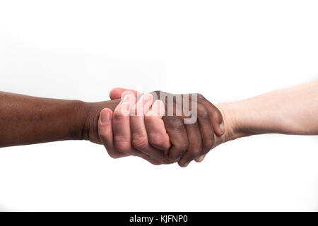 Close up view of a black / african man and a white / caucasian man shaking hands from below Stock Photo