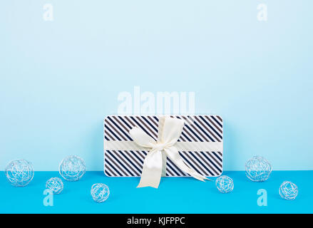 Christmas background with decorations and gift boxes on blue board. Stock Photo