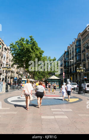 BARCELONA, SPAIN - SEPTEMBER 2: Joan Miro's Pla de l'Os mosaic in La Rambla on September 2, 2017 in Barcelona, Spain. People walks at famous La Rambla Stock Photo