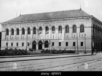 An exterior photograph of the Boston Public Library McKim Building, it was built in 1895 in Copley Square, it featured the first 'children's room' in the country, the large stonework building is known for its regular displays of rare books and artworks, people can be seen walking on the street and a horsedrawn carriage is parked in front of the main entrance, Boston, Massachusetts, 1905. Stock Photo