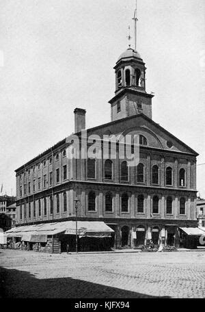 An exterior view of Faneuil Hall, it has served as a meeting hall and marketplace since 1743, pro-independence speeches were given there prior to the start of the American Revolutionary War, the sidewalk around most of the building is covered by a tent and items in crates can be seen underneath, Boston, Massachusetts, 1905. Stock Photo