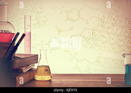 Classroom desk of chemistry teaching with books and instruments. Chemical sciences education concept. Horizontal composition. Front view Stock Photo