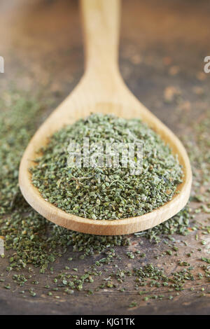 Stinging nettle (Urtica dioica) seeds in wooden spoon Stock Photo
