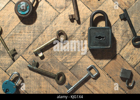 Old padlocks and keys on wood Stock Photo