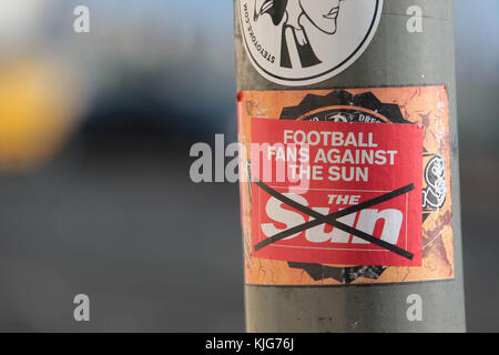 Football fans against The Sun Newspaper sticker on a lampost in Brighton Stock Photo
