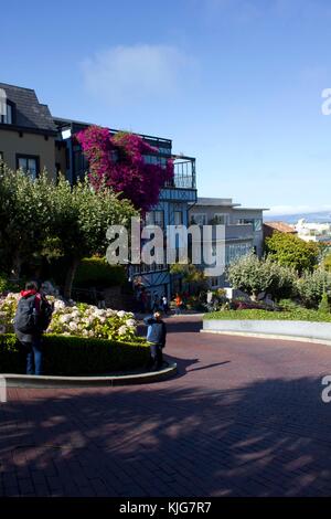 SAN FRANCISCO, USA - AUG 11 2013: The famous Lombard Street in San Francisco, famous for its steep, one-block section with eight hairpin turns, with i Stock Photo