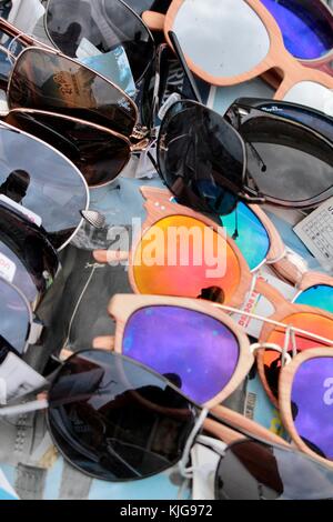 Box of different sunglasses on display on a market stall in London. Stock Photo