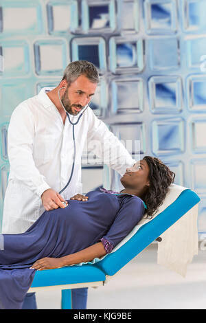 Handsome caucasian doctor in white coat is consulting beautiful african pregnant woman in his office Stock Photo