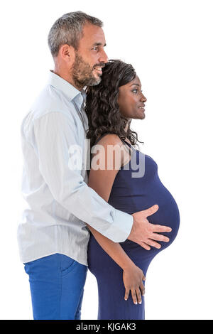 Couple with hands on baby belly of pregnant woman in a white background Stock Photo
