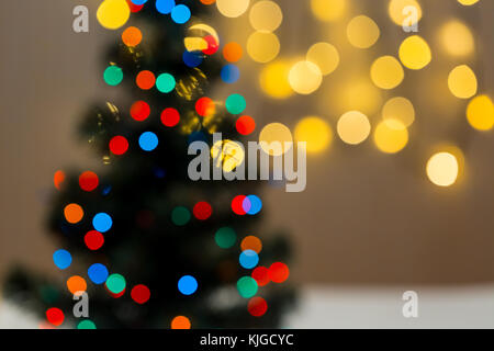 Gold Christmas background of de-focused lights garland with decorated tree Stock Photo