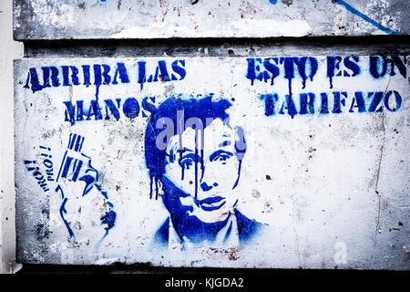 Protest graffiti against President Macri in Buenos Aires, Argentina.  The text translates as 'hands up, this is a price hike'. Stock Photo