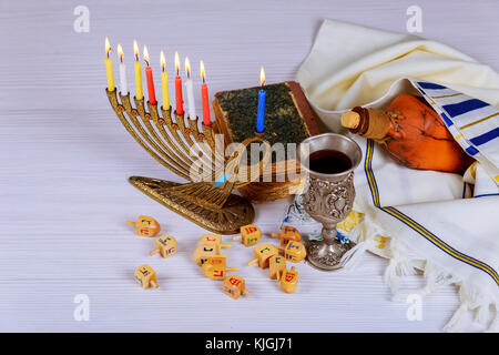 Jewish holiday hannukah prayer shawl, jewish cap and nine candle menorah Stock Photo