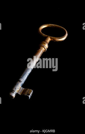 old rusty key on black background Stock Photo