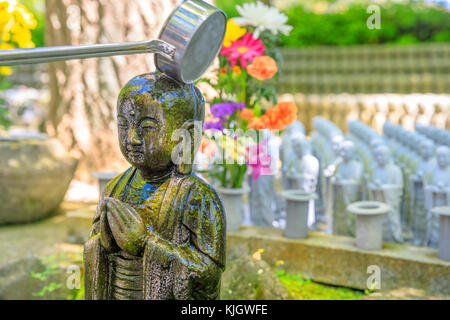 Worshipping at Jizo Statue Stock Photo