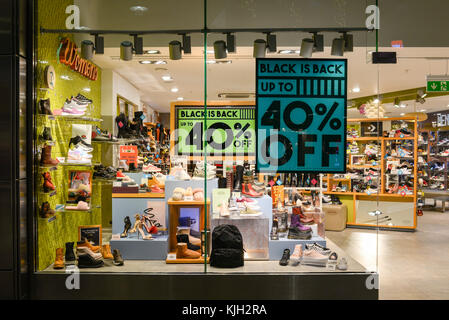 Black Friday sale signs in the windows of shoe retailer Schuh, Westquay shopping centre, Southampton, Hampshire, UK. 24th November, 2017. Shops in the prestigious south coast retail venue prepared for the annual pre-Christmas shopping discount bonanza day. Stock Photo