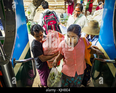 Yangon, Yangon Region, Myanmar. 25th Nov, 2017. Passengers climb aboard the Yangon Circular Train in Danyingon station, in the middle of the train's loop. The Yangon Circular Train is a 45.9-kilometre (28.5 mi) 39-station two track loop system connects satellite towns and suburban areas to downtown. The train was built during the British colonial period, the second track was built in 1954. Trains currently run both directions (clockwise and counter-clockwise) around the city. The trains are the least expensive way to get across Yangon and they are very popular with Yangon's working class. Stock Photo