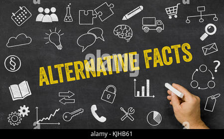 Alternative facts written on a blackboard with icons Stock Photo