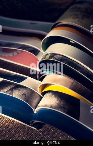 Many opened journals. Sun light. Stock Photo