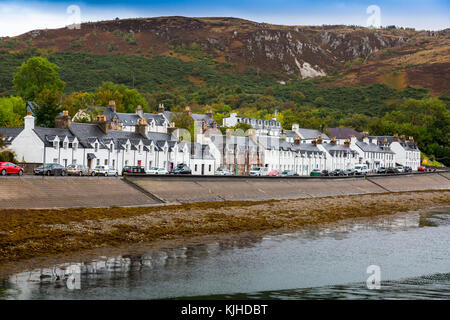 A terrace of waterfront houses and shops facing Loch Broom on Shore Street in Ullapool, Highland, Scotland, UK Stock Photo