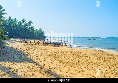 BENTOTA, SRI LANKA - DECEMBER 6, 2016: The comfortable beaches of Ceylon are famous among the foreign tourists and local fishermen, on December 6 in B Stock Photo