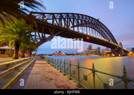 Sydney Opera House and the Harbour Bridge early in the morning just before sunrise as it was seen from Luna Park in Milsons Point, NSW, Australia Stock Photo