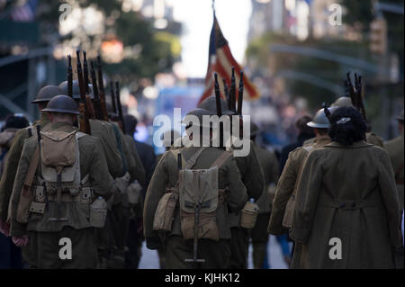 Historical reenactors representing U.S. Soldiers and Marines during a World War I, march in a Veterans Day Parade in New York City, N.Y., Nov. 11, 2017 . This year the U.S. Air Force was honored as the featured service during the parade. With more than 40,000 participants, the New York City Veterans Day Parade is the largest Veterans Day event in the United States. (U.S. Air National Guard Photo by Staff Sgt. Christopher S. Muncy) Stock Photo