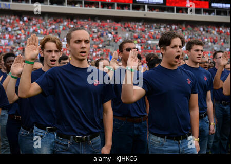 Military recruits recite the oath of enlistment given by Marine Lt. Gen. Joseph Osterman, deputy commander of U.S. Special Operations Command, during the Tampa Bay Buccaneers Salute to Service game in Tampa, Fla., Nov. 15, 2017. The game provided the NFL and fans a forum to honor service members, veterans and their families. (Photo by U.S. Air Force Master Sgt. Barry Loo) Stock Photo