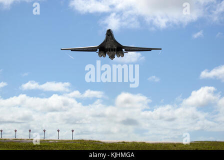 A U.S. Air Force B-1B Lancer assigned to the 37th Expeditionary Bomb Squadron, deployed from Ellsworth Air Force Base, South Dakota, takes off from Andersen AFB, Guam for a mission flying in the Western Pacific, Nov. 13. Two bombers integrated with F-16 Fighting Falcons from Misawa Air Base, Japan and Osan AB, Republic of Korea, and two KC-135s from Andersen AFB, Guam, and performed a flyover of the USS Ronald Reagan (CVN 76), USS Nimitz (CVN 68) and USS Theodore Roosevelt (CVN 71) Carrier Strike Groups during the training. (U.S. Air Force photo by Airman 1st Class Gerald R. Willis) Stock Photo