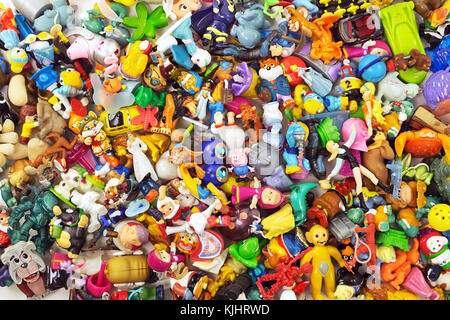 Heaps of the different small toys including Kinder Surprise as a background Stock Photo