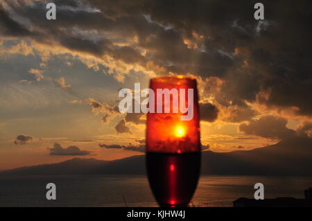 At the smell of an autumn fantasy day happened to me to see amazing sunset through a drop of wine in my glass Stock Photo