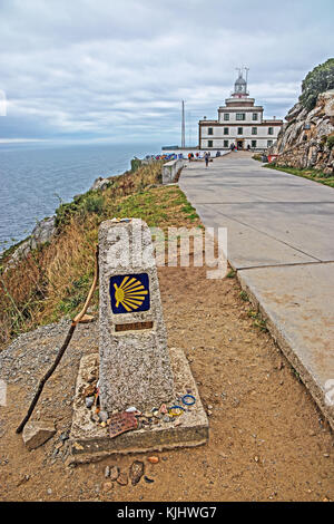 Fisterra lighthouse (Cape Finisterre), also scallop munument- marking end of Camino de Santiago pilgrimage route Stock Photo