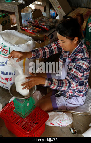 Khmer shopkeeper at work. Battambang.  Cambodia. Stock Photo