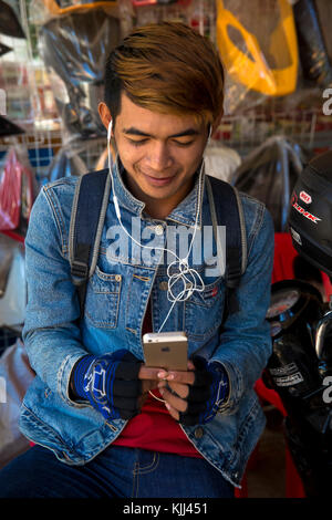 Young Cambodian using a cell phone. Battambang.  Cambodia. Stock Photo