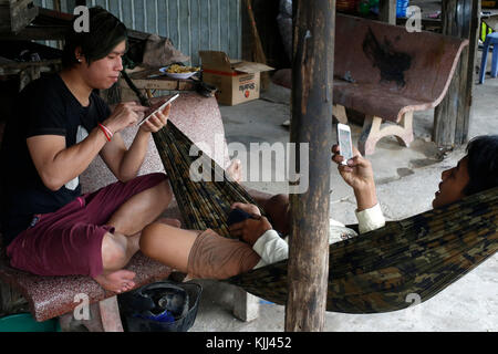 Young Khmers using cell phones. Battambang.  Cambodia. Stock Photo