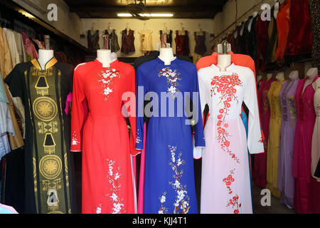 Vietnamese shop front selling traditional women's dress: the Ao Dai. Hoi An. Vietnam. Stock Photo