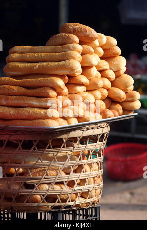 Woman selling french style bred in market.  Thay Ninh. Vietnam. Stock Photo