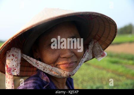 Vietnamese woman wearing traditional conical hat. Hoi An. Vietnam.