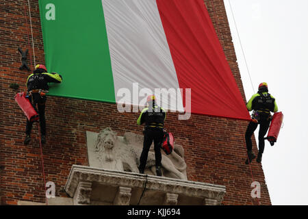 Vicenza, VI, Italy - December 4, 2015: Firefighters with a big italian flag on an ancient Palace called Basilica Palladiana during an exercise Stock Photo