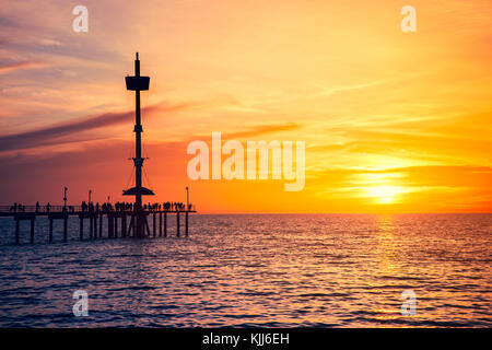 People enjoying sunset from Brighton Jetty, South Australia Stock Photo