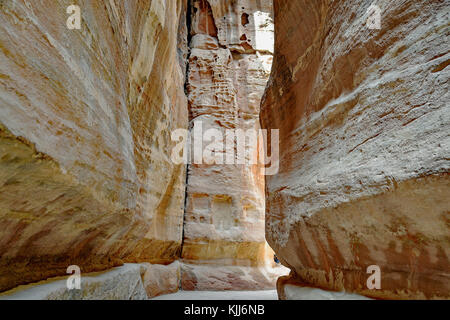 Pathway to the ancient city of Petra, Jordan. The pathway is a Siq - narrow gorge carved by water flow. Stock Photo