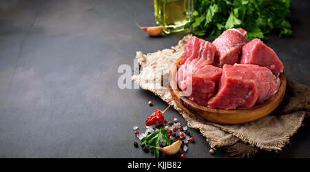 Raw chopped meat with spices on rusty background. Selective focus Stock Photo