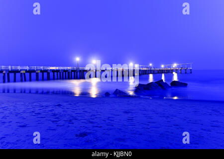 Pier and rocks on the beach. View from Coney Island Beach, Brooklyn, New York. Stock Photo