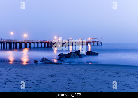 Pier and rocks on the beach. View from Coney Island Beach, Brooklyn, New York. Stock Photo