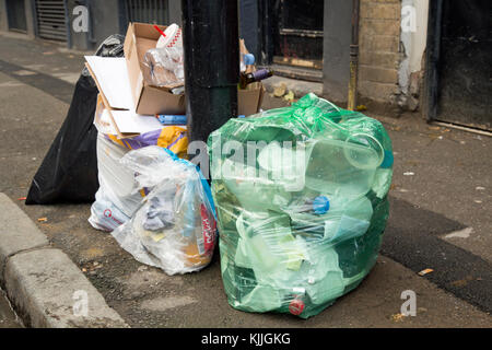 London, England, November 2017, Bags of rubbish in different colour sacks await collection on the street Stock Photo